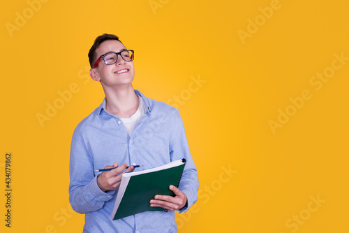 A handsome guy in a blue shirt on a yellow background