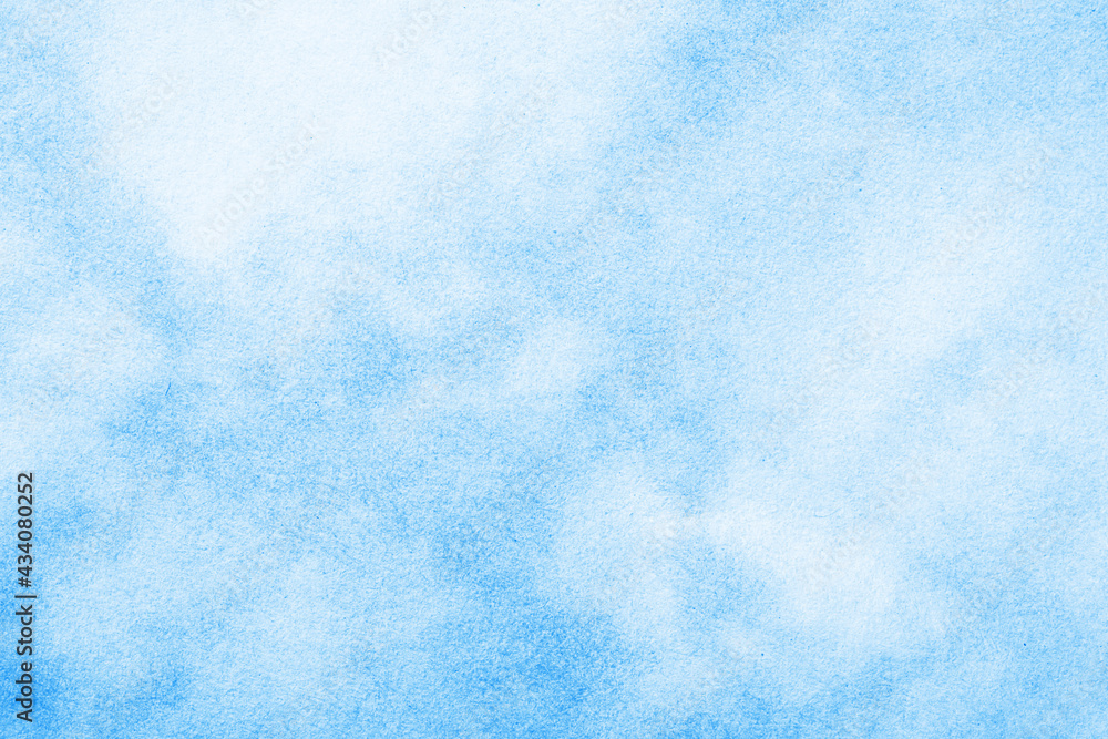 Blue ink splashes on white paper. Spray paint grain background. Heaven texture. Blue cloudy sky abstract pattern. Noise backdrop.