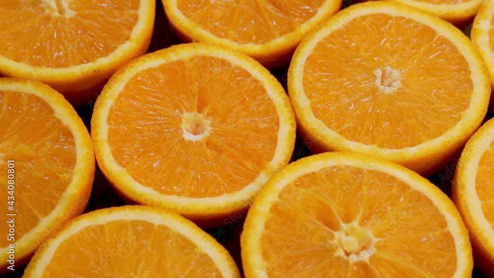 Abstract Background of Rotating Orange Halves. Many Fresh Orange Halves Are Isolated. Orange halves Close-up. Abstract Background of Rotating Orange Halves. Many Fresh Orange Halves Are Isolated. Orange halves Close-up.