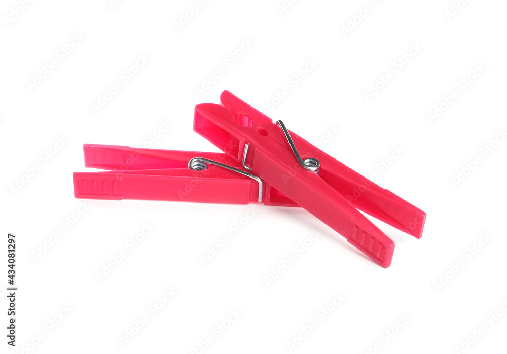 Bright pink plastic clothespins on white background Bright pink plastic clothespins on white background