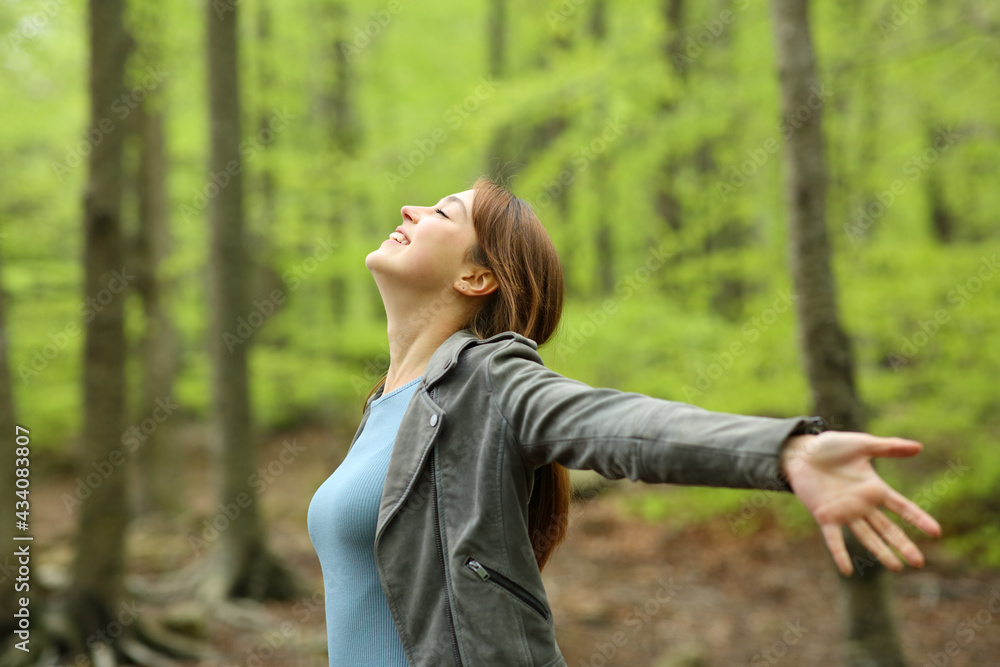 Happy woman spreading in a green forest Happy woman spreading in a green forest