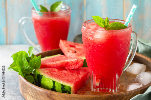 Summer cold drink. Refreshing Watermelon drink in glasses and slices of watermelon on a stone tabletop.