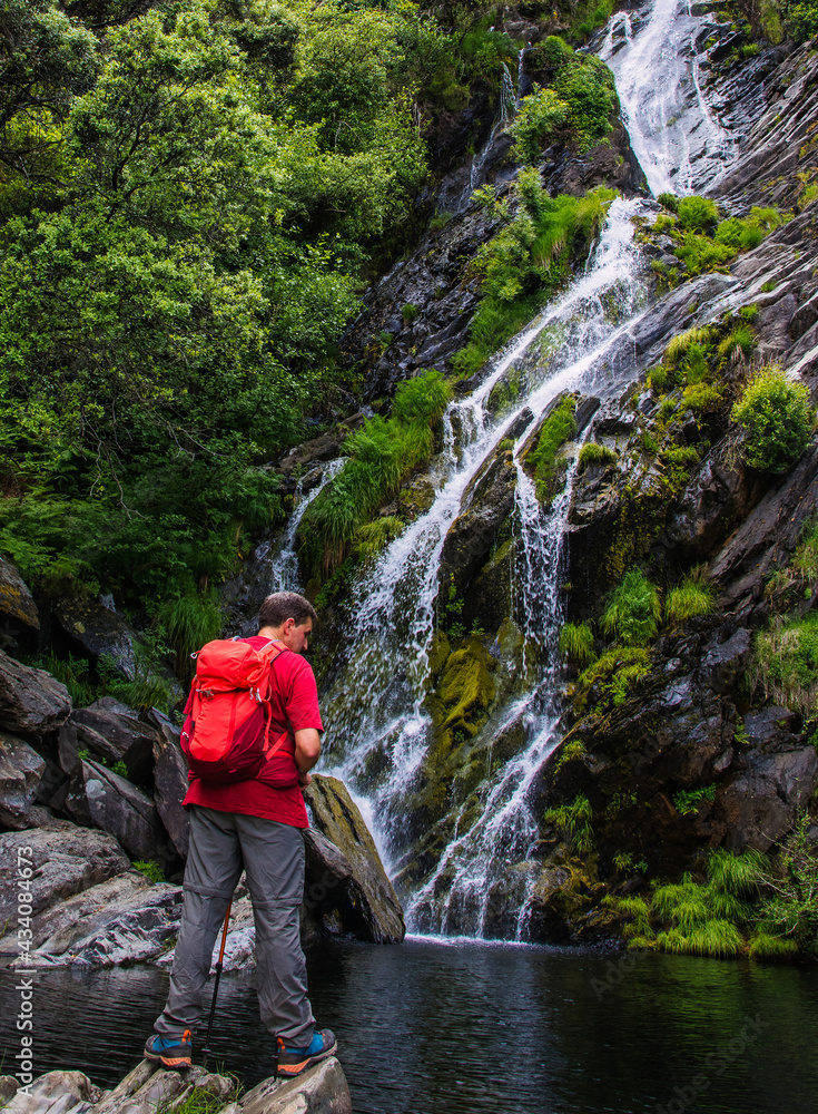 Hiking And Waterfall.
A hiker hiking outdoors in nature stops to look at an impressive waterfall. Las Hurdes Located North Of Cáceres- Spain. Hiking And Waterfall.
A hiker hiking outdoors in nature stops to look at an impressive waterfall. Las Hurdes Located North Of Cáceres- Spain.