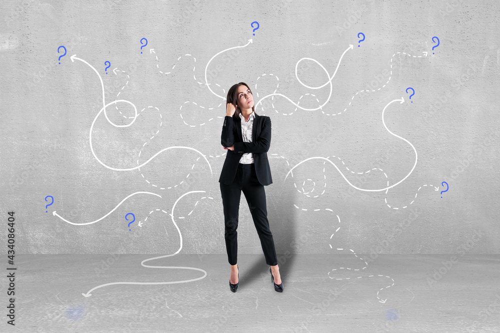 Business choice concept with woman in black suit on concrete wall background with lots of curved lines and question marks. Business choice concept with woman in black suit on concrete wall background with lots of curved lines and question marks.