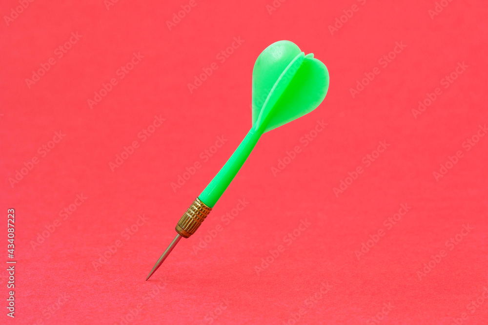 Green dart arrow on the red background Green dart arrow on the red background