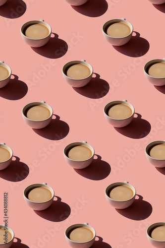 Cup of coffee pattern on pink background. Sunlight minimal trendy concept