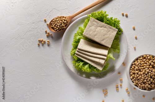 Fresh tofu (tahu) cheese with natural organic soy beans in ceramic bowl on white background. The concept of healthy food. Vegetarian protein