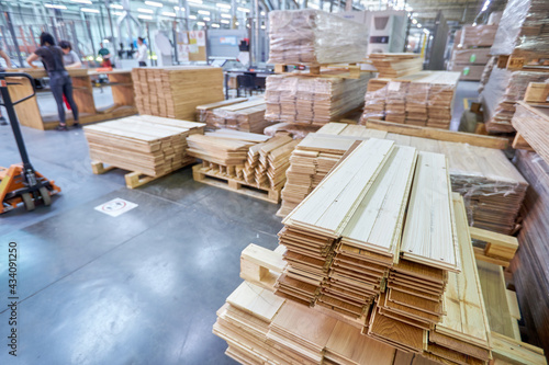 Carpentry factory. Modernized woodworking manufacture. Robotic equipment composing wooden panels inside the parquet floor factory.
