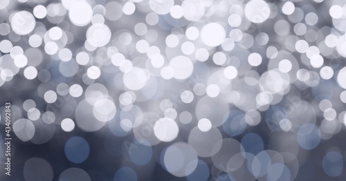 Digital generated image of spots of bokeh lights against grey background photo