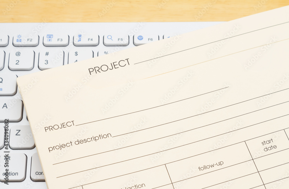 Manila project plan folder on a keyboard Manila project plan folder on a keyboard
