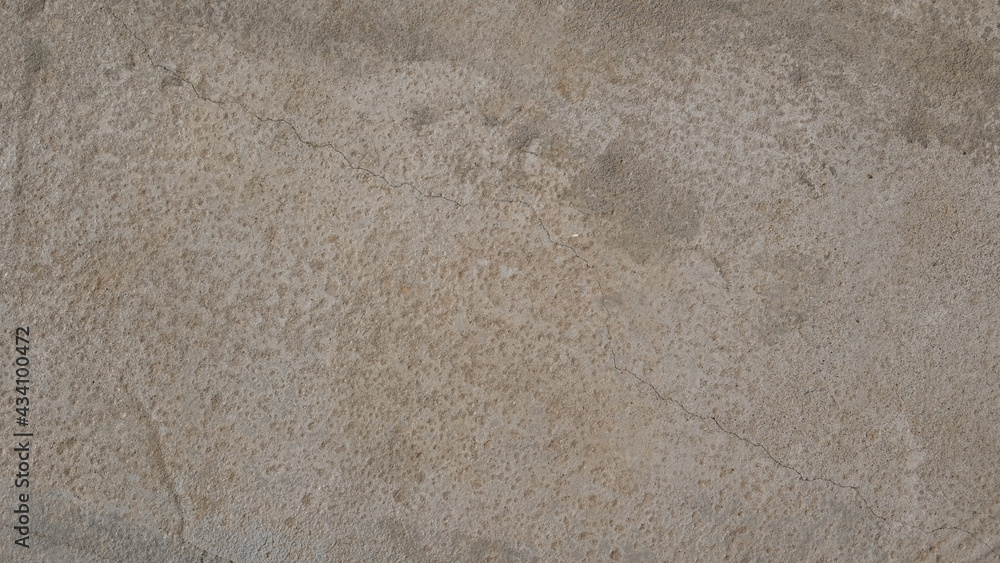 Textured concrete background. Old wall or floor made of beige plaster. Scuffed and cracked. Copy space. Attrition.