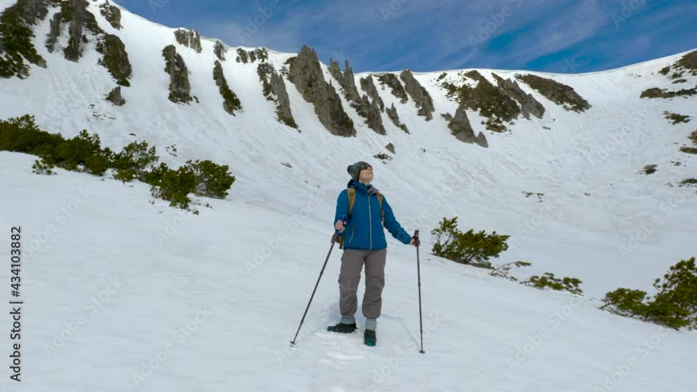 Young woman with a backpack travels in the mountains Young woman with a backpack travels in the mountains