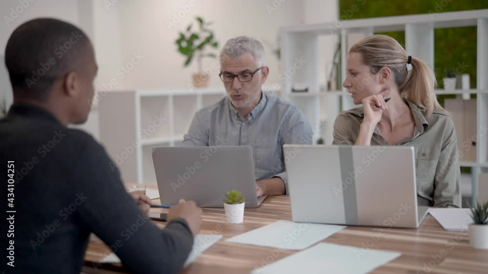 Business people in modern meeting room working together on project Business people in modern meeting room working together on project