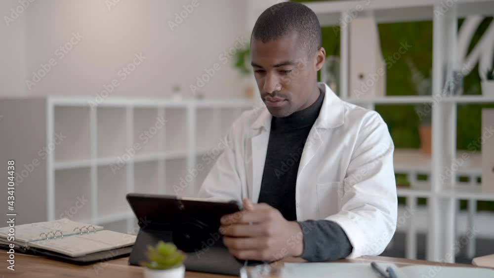 Doctor in office working on digital tablet Doctor in office working on digital tablet