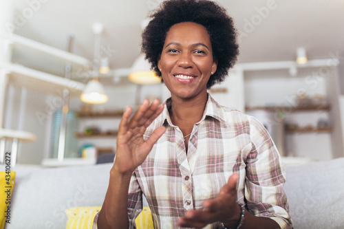 Portrait african american woman gesturing with hands at home.