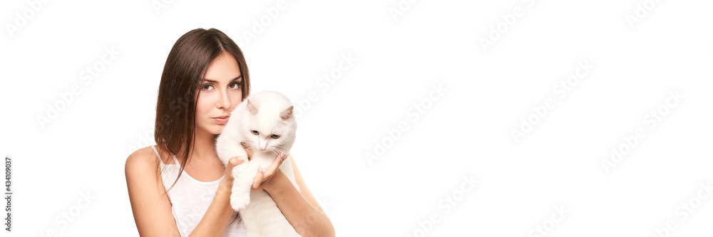 Young woman holding white cat. Allergy concept. Pretty animal. Lifestyle. Human and pet Young woman holding white cat. Allergy concept. Pretty animal. Lifestyle. Human and pet