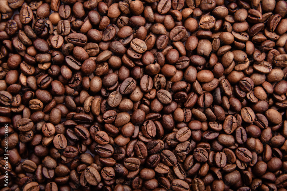 Freshly roasted coffee beans background close-up Freshly roasted coffee beans background close-up