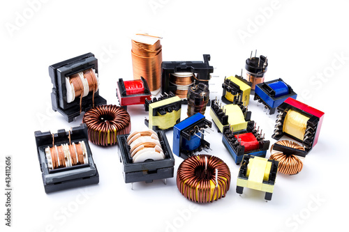 Set of toroidal inductors with copper wire and electric transformers, electronic component, isolated on white background photo