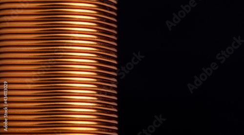 Close-up copper wire coil on black background. Copper wire industry for general electrical work with copy space on the right photo