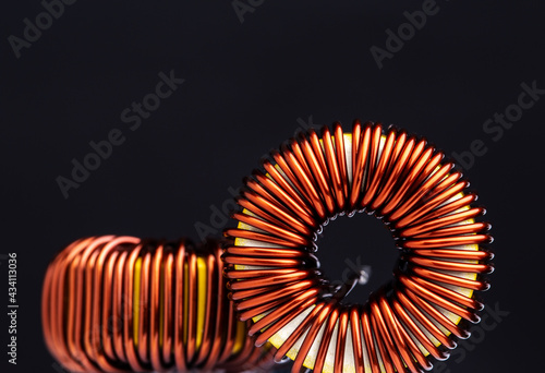 Close-up of copper wire coil on black background. photo
