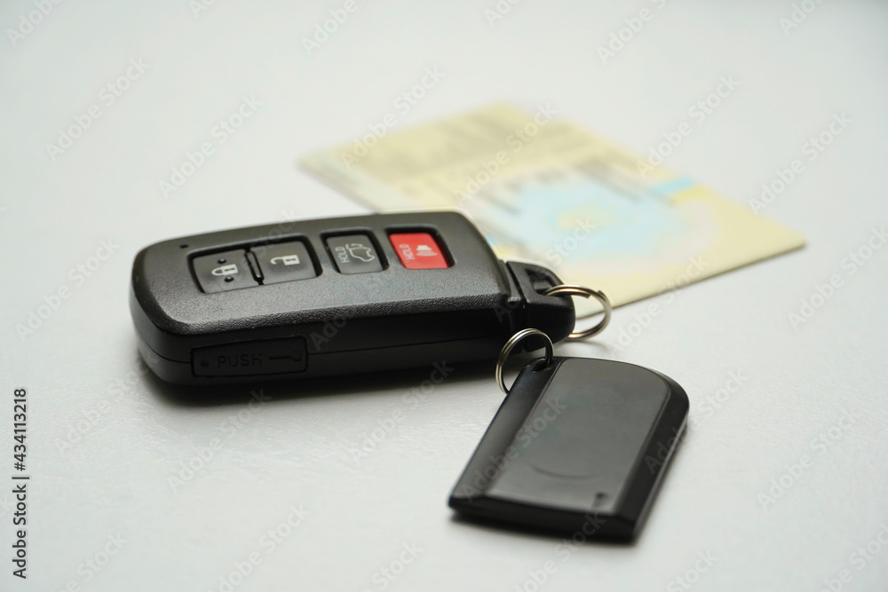 Fototapeta premium Car key with remote control and alarm system key ring. Motor transport insurance.