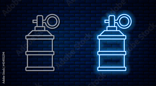 Glowing neon line Hand smoke grenade icon isolated on brick wall background. Bomb explosion. Vector