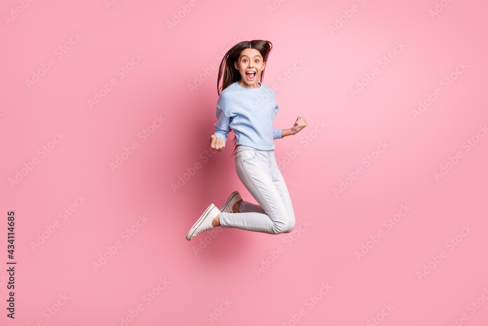 Full length body size view of pretty cheerful girl jumping having fun rejoicing great triumph isolated over pink pastel color background