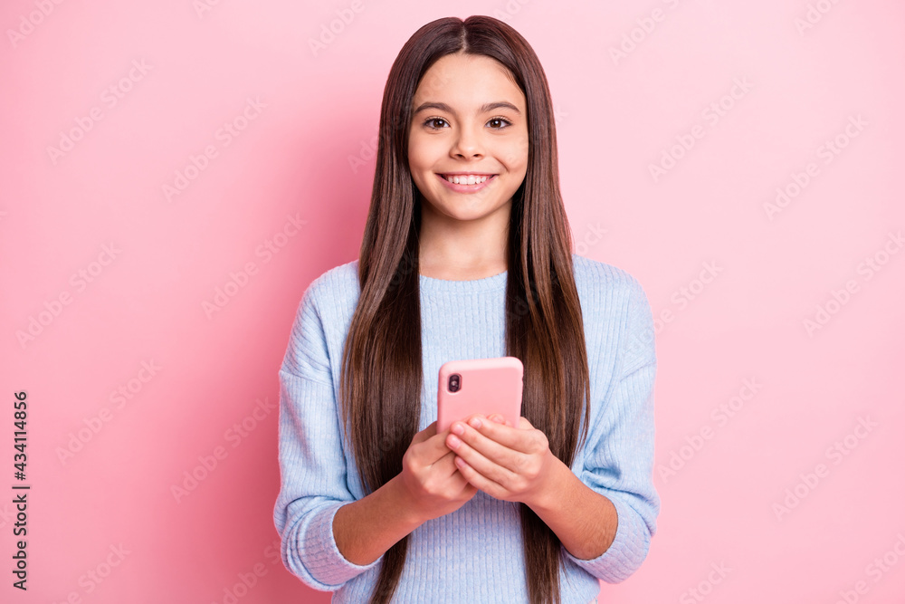 Portrait of attractive cheerful girl using device browsing media multimedia isolated over pink pastel color background Portrait of attractive cheerful girl using device browsing media multimedia isolated over pink pastel color background