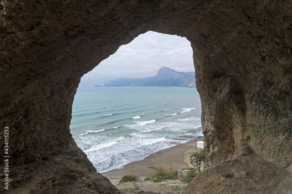 View of the sea from a small cave on the slope of the coastal mountain.