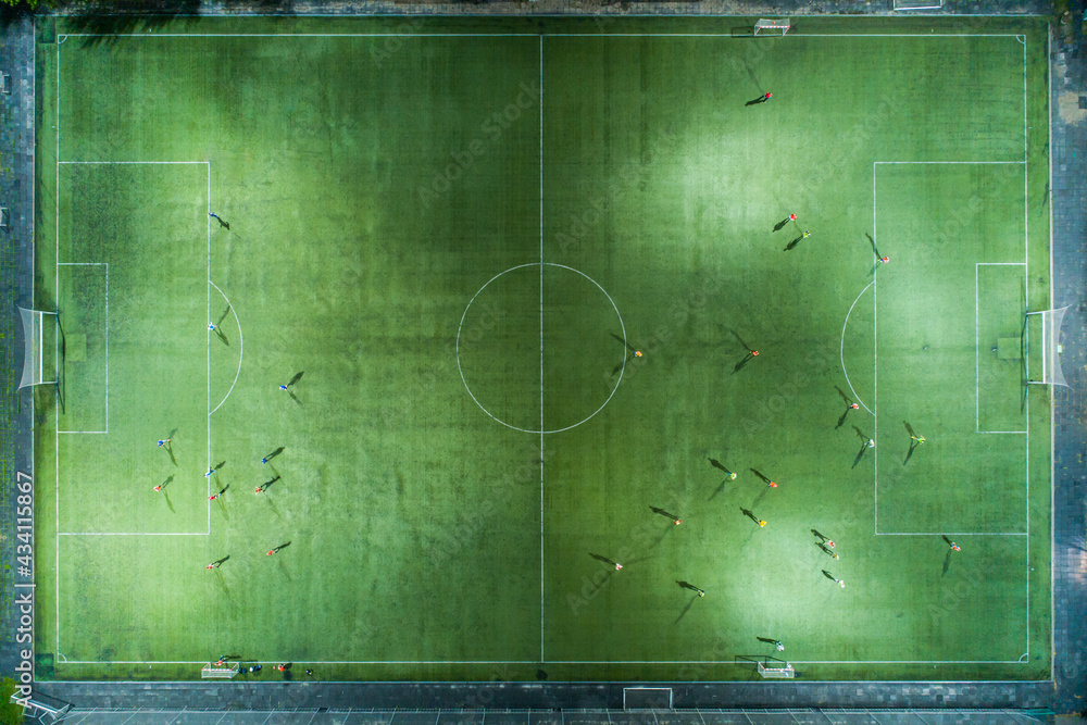 Stadium at night. Night football match. Two teams play football under the spotlights. Night workout Stadium at night. Night football match. Two teams play football under the spotlights. Night workout