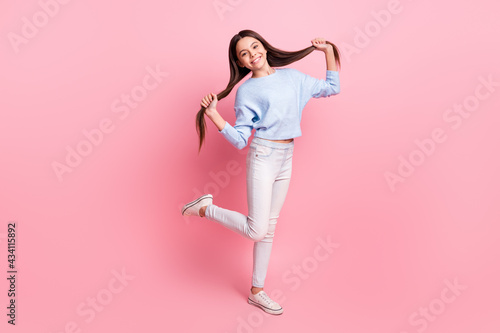 Full length body size view of pretty cheerful girl dancing having fun making tails isolated over pink pastel color background