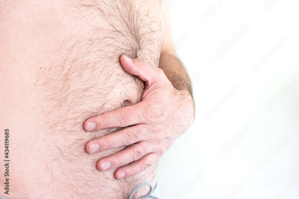 Caucasian male hand grabbing naked hairy belly fat close up isolated shot unrecognizable