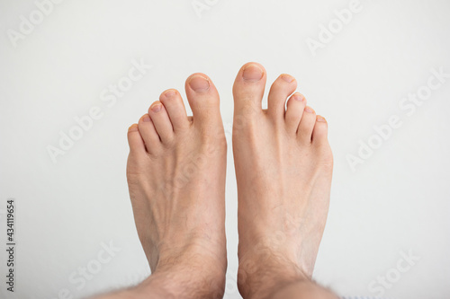 Caucasian male bare feet top view close up shot isolated on white photo