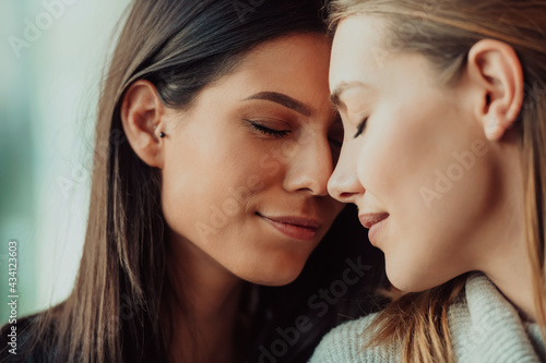 Diverse friends girls lesbian couple hugging. Stylish cool generation z women dating in love enjoy romantic relationships