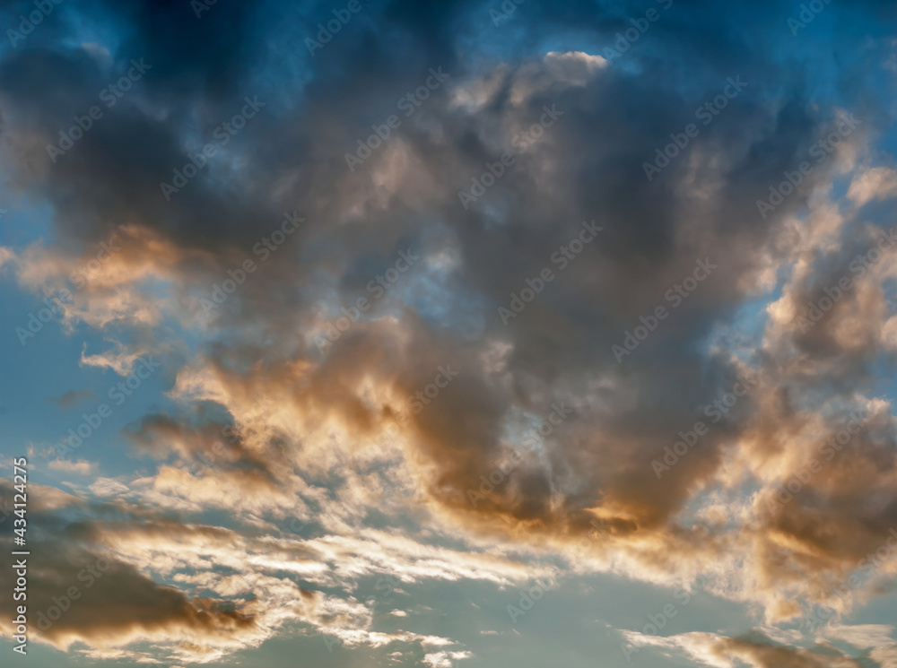 Orange Clouds in Evening Light of Sunset on Blue Sky Background - Overcast Western Sky in Spring Dusk Time - Belarus Minsk