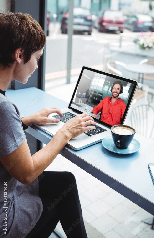 Asian businesswoman in cafe using laptop having video call with male colleague Asian businesswoman in cafe using laptop having video call with male colleague