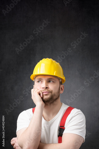 Disappointed construction worker with yellow hard hat