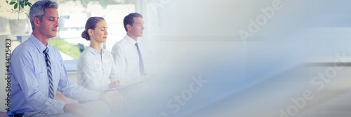 Several businessman practicing meditation and relaxing at the office with office background concept