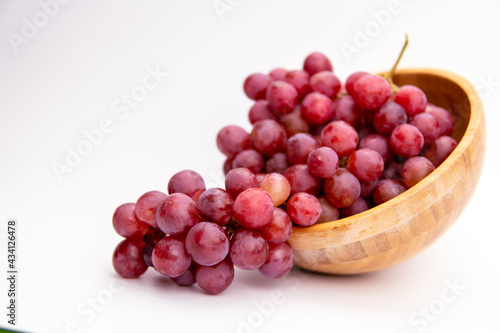 Wallpaper Mural Red grapes in a wooden bowl isolated on white background. Fresh bunch of fruits. Selective focus Torontodigital.ca