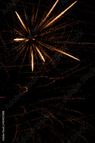 fireworks with yellow sparks on black background