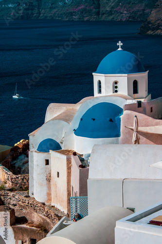Greek white church with blue dome in Santorini.
