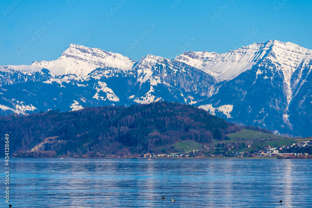 Obraz premium Stunning alpine landscapes along the shores of the Upper Zurich Lake with the iconic Santis peak in the background, Rapperswil-Jona, St. Gallen, Switzerland