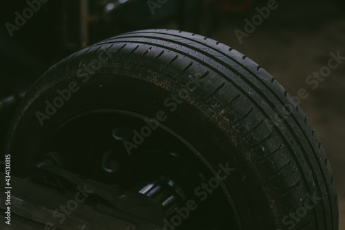 Closeup of a large tire in a workshop with a little bit of dirt on it