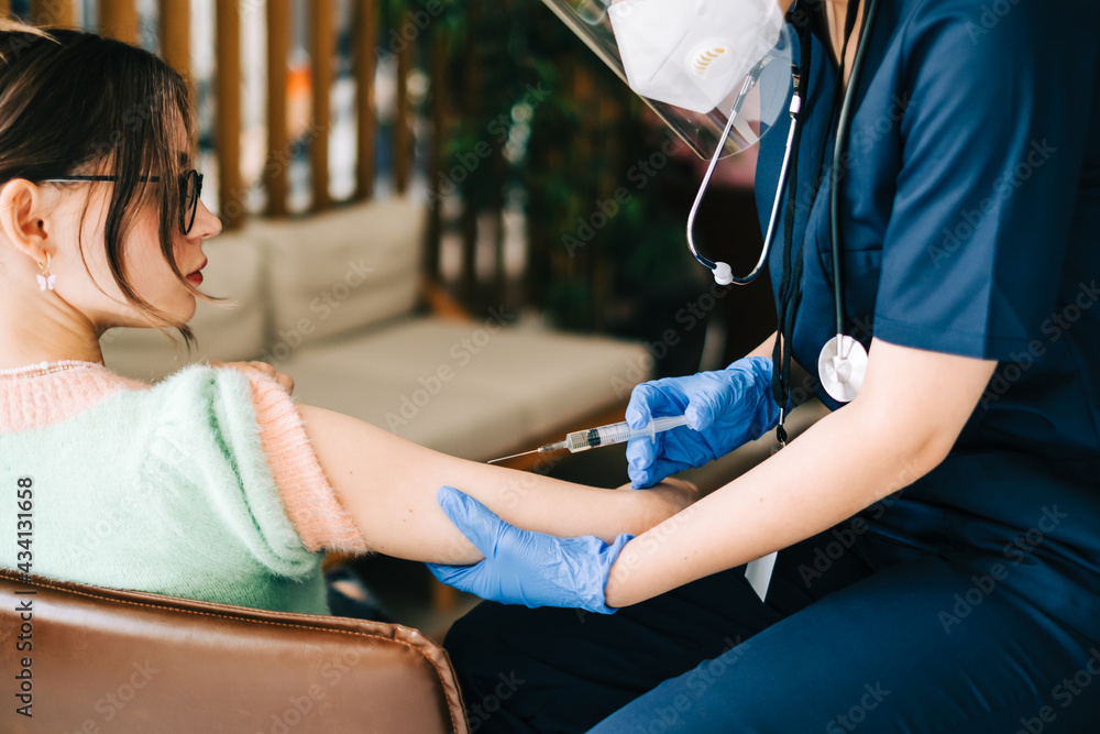 Obraz premium Caucasian woman patient getting vaccinated against coronavirus receiving covid vaccine. Intramuscular injection during doctor's appointment in hospital. Covid-19 Vaccination.