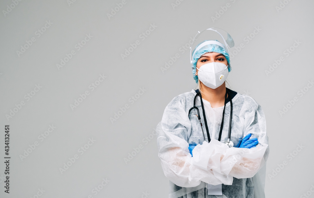 Young woman nurse hospital worker in medical protective mask, gloves and protective wear isolated on white background with copy space.