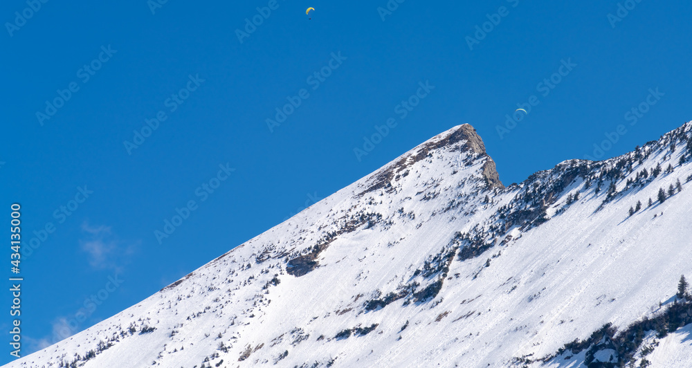 Paragliding around the iconic Speer peak near the resort town of Andem in the canton of St. Gallen, Switzerland