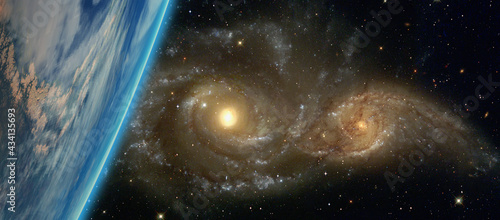 Fototapeta Naklejka Na Ścianę i Meble -  Galactic disaster - Collision of two galaxies planet earth in the foreground 
