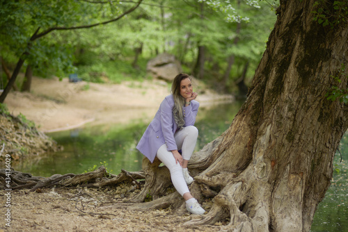 Beautiful young teen women in nature. Woman breathing fresh air in a green forest in summer 