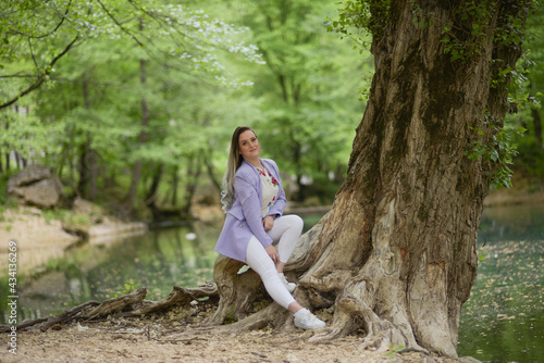 Beautiful young teen women in nature. Woman breathing fresh air in a green forest in summer 