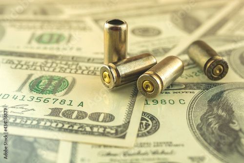 Bullet for gun trade and crime problem concept, bullet on dollar background